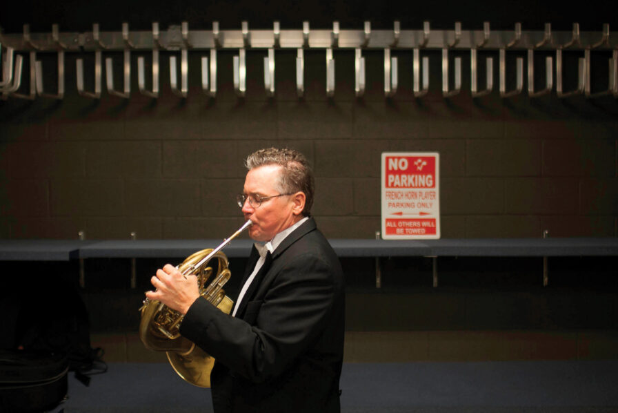 Horn faculty member Jeffrey Lang warms up backstage at Verizon Hall
